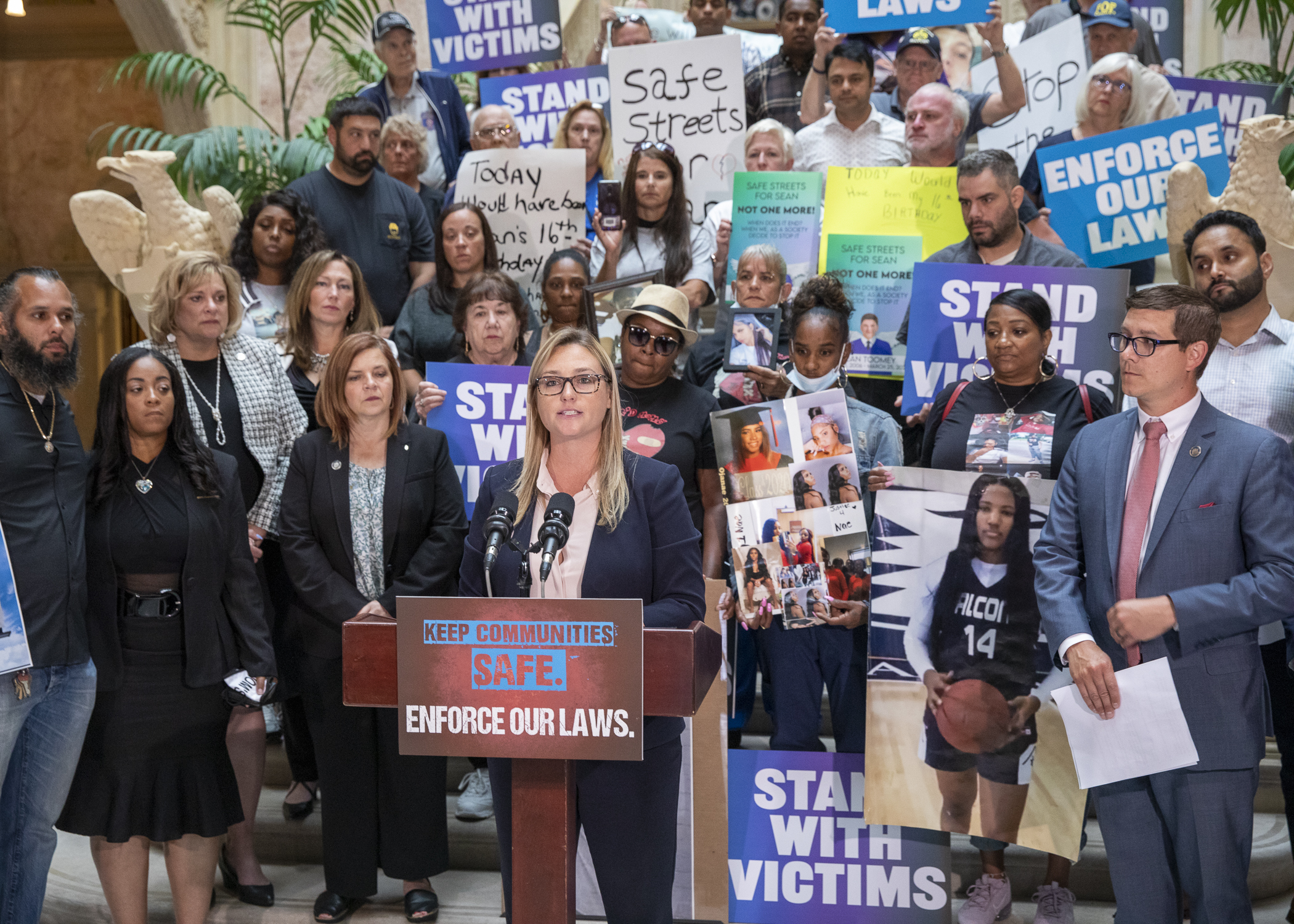 Rep. Martina White stands before the families of crime victims who gathered in Harrisburg to call for the impeachment of Philadelphia District Attorney Larry Krasner. 